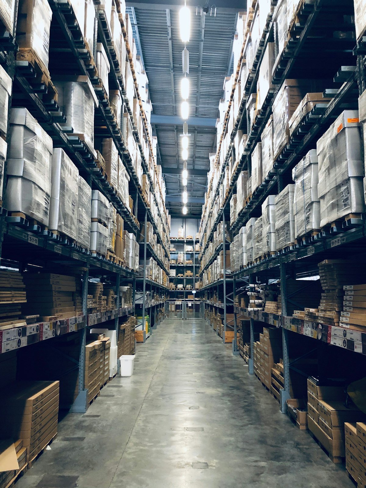 Aisle of racked pallets inside a logistics warehouse